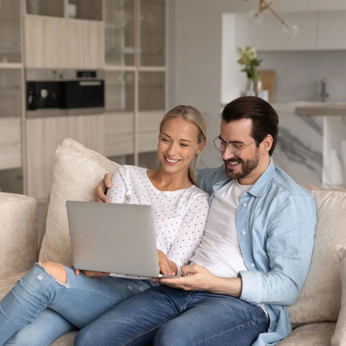 Couple browsing listings on a laptop