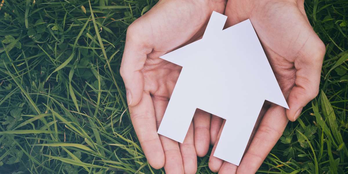 photo of someone with a house in their hand buying a home in Manor, Tx